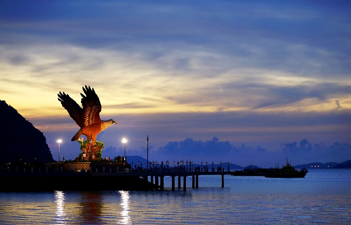 The Eagle Square landmark at dusk over the water in Langkawi